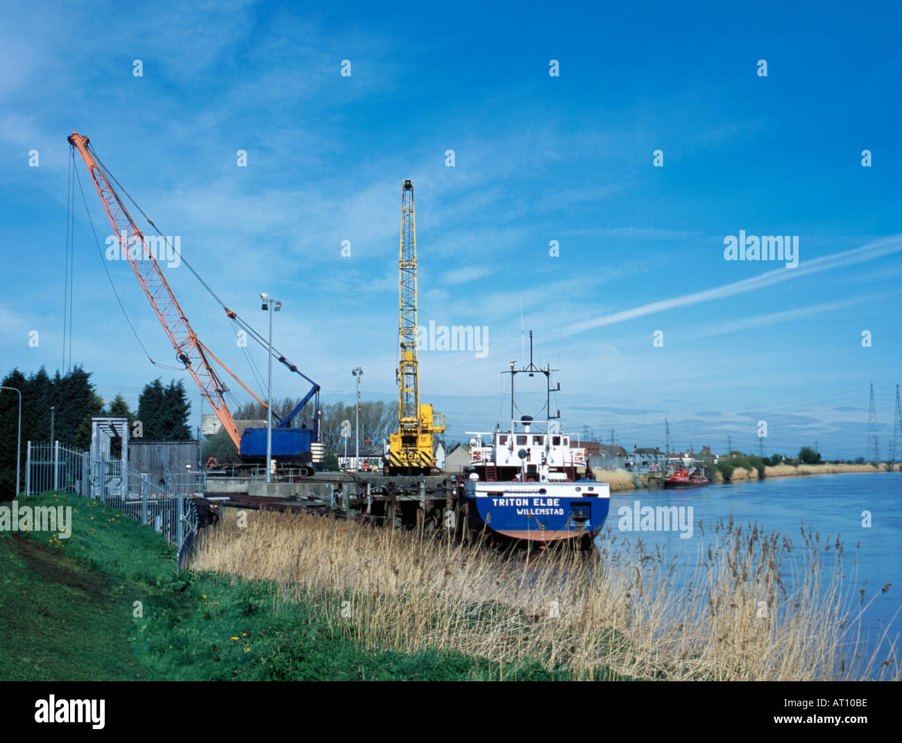 Riverside mobile cranes and moored freighter, River Trent, Keadby, near Scunthorpe, North