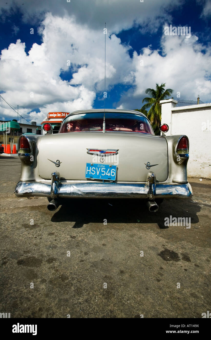 Old American Chevy (Chevrolet) sits parked at a garage in Havana (Cuba). Classic American cars are seen throughout Cuba. Stock Photo