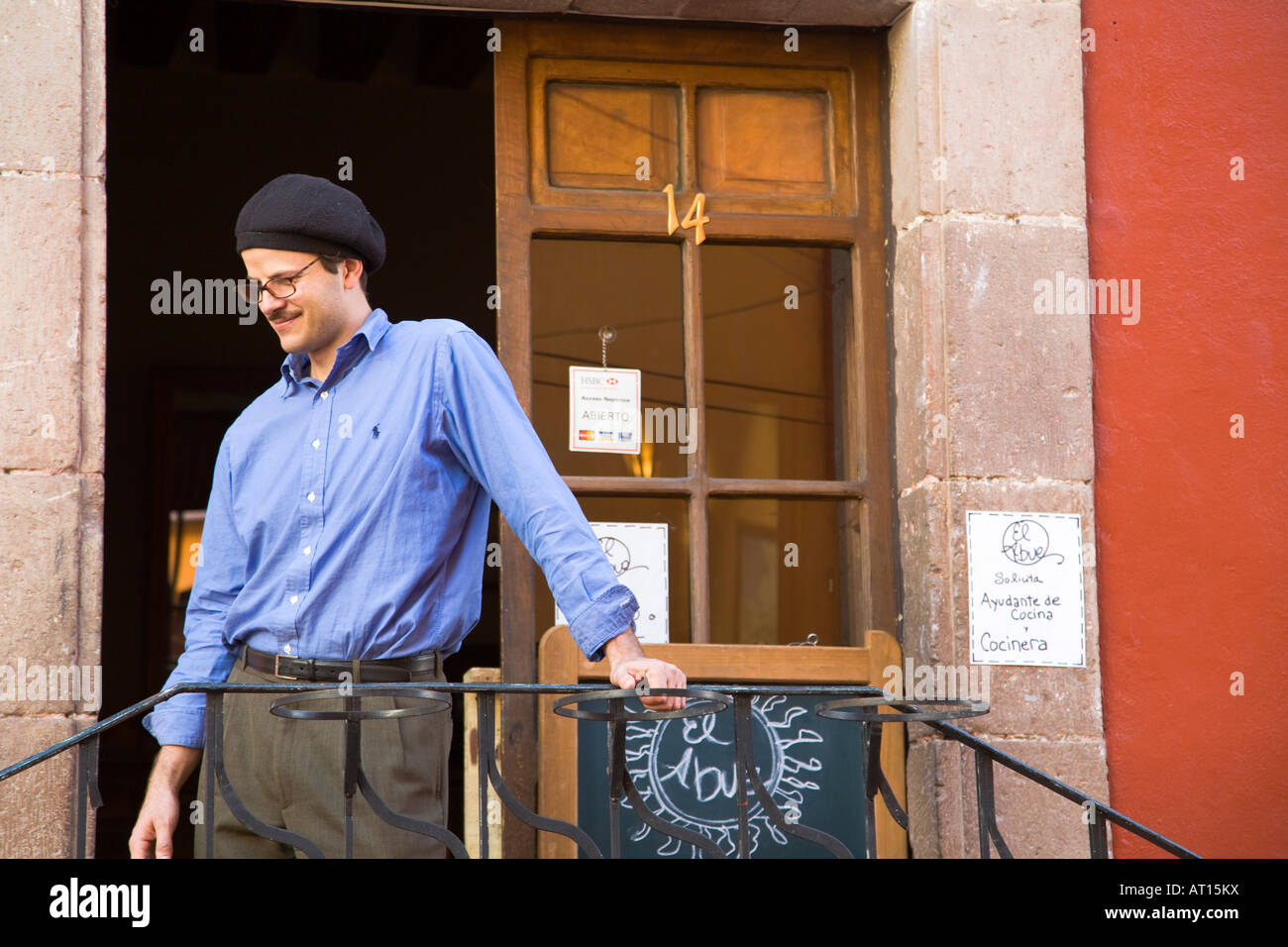 MEXICO Guanajuato Adult male with beret standing outside restaurant with open door Stock Photo