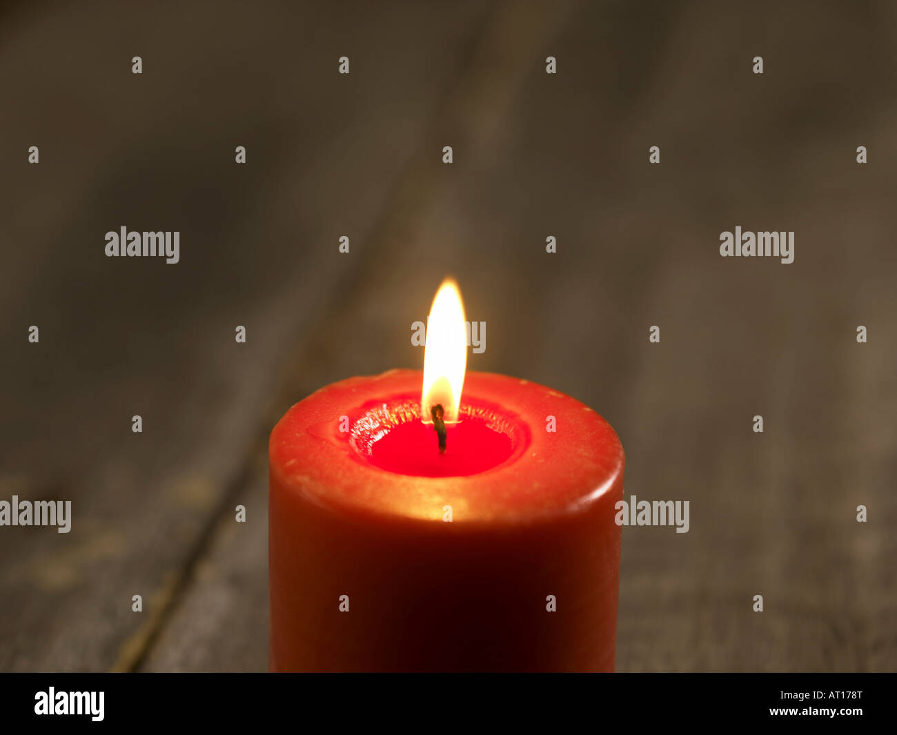 Lit red candle Stock Photo Alamy