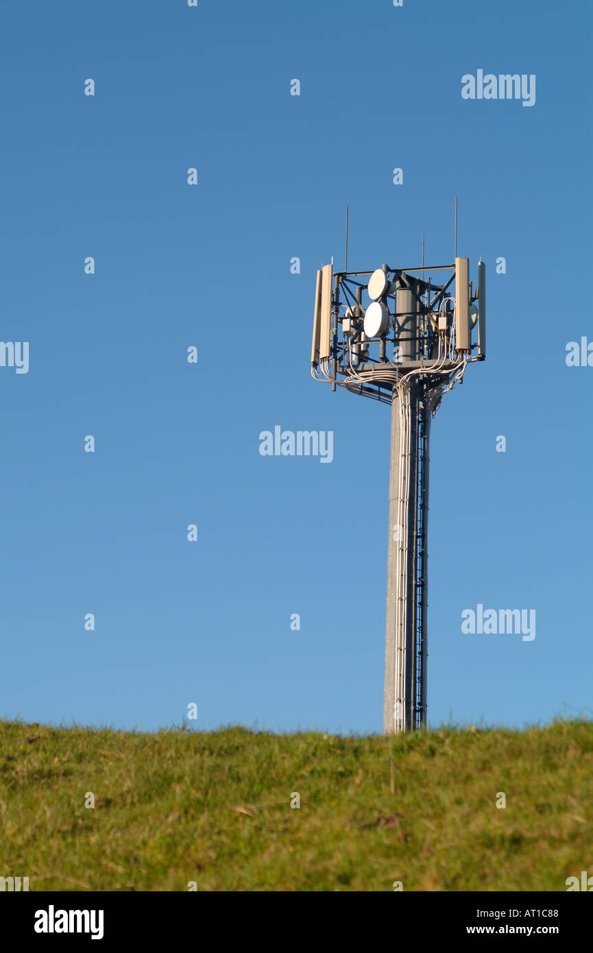 Communication mast in countryside field with blue sky Stock Photo - Alamy