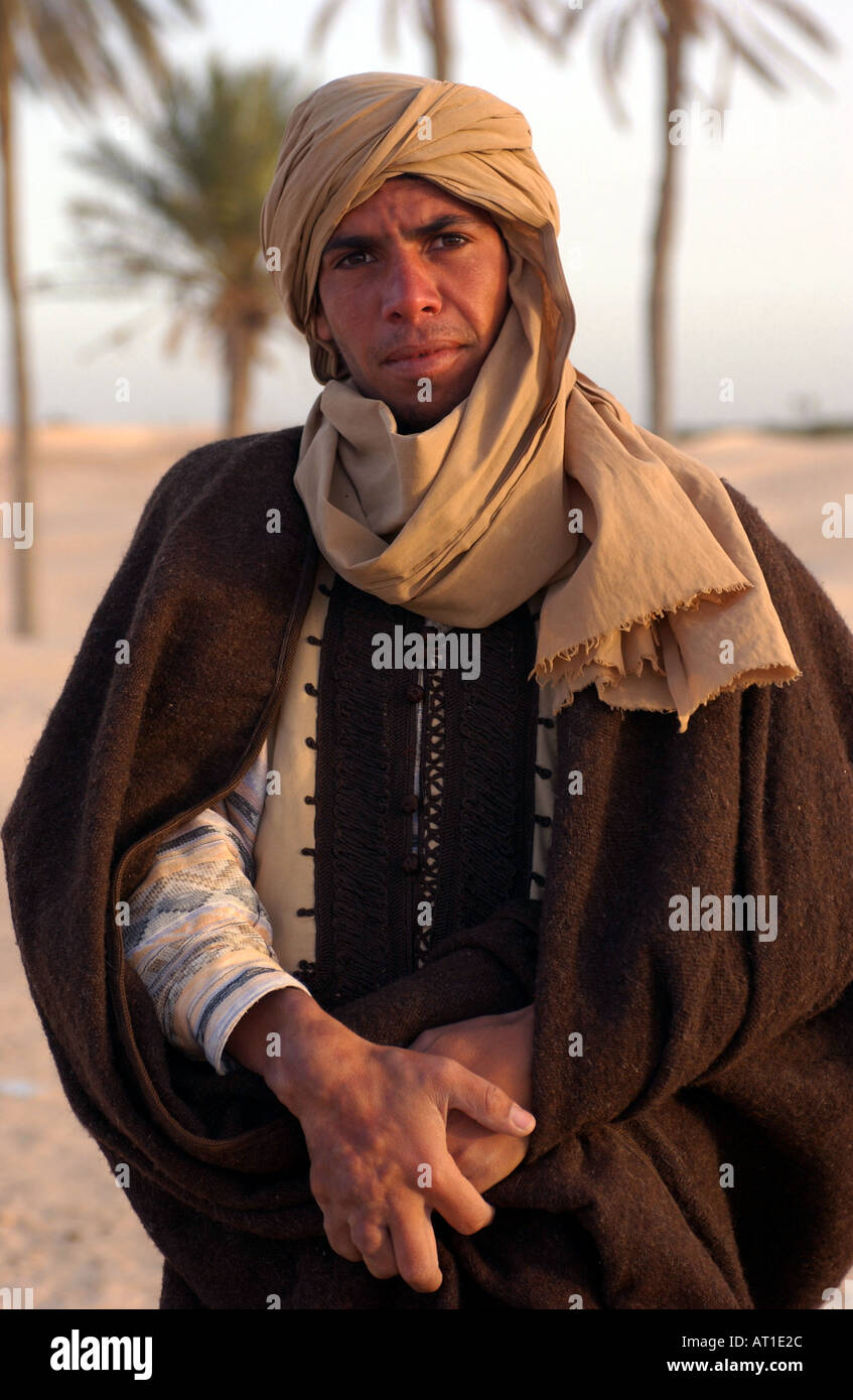 A nomadic Bedouin at dawn in the Sahara Desert near the town of Douz ...