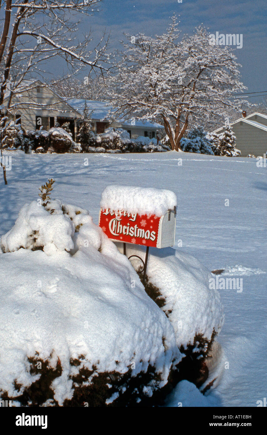 Merry Christmas banner on a snow covered mailbox in suburban USA in the 1950s Stock Photo