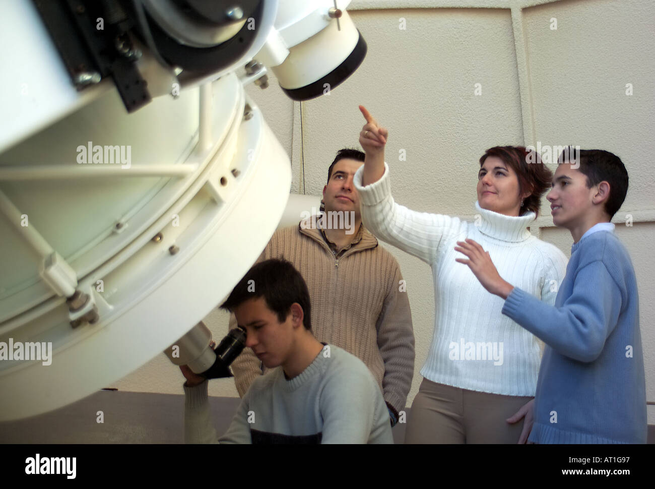 Family watching the skies with telescope Stock Photo
