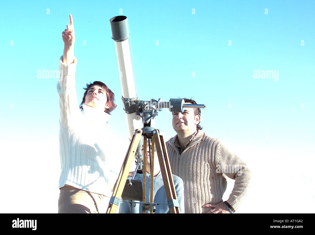 Family watching the skies with telescope Stock Photo