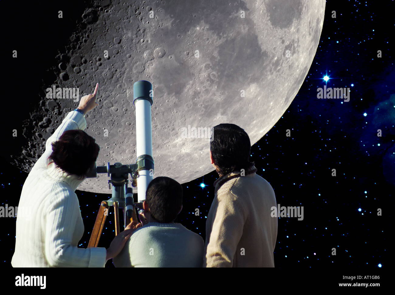 Family watching the moon with telescope Stock Photo