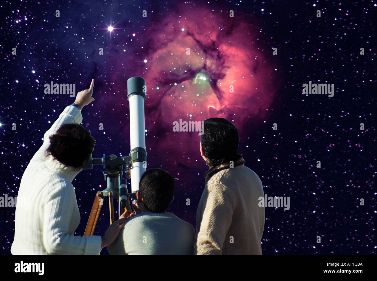 Family watching the universe with telescope Stock Photo