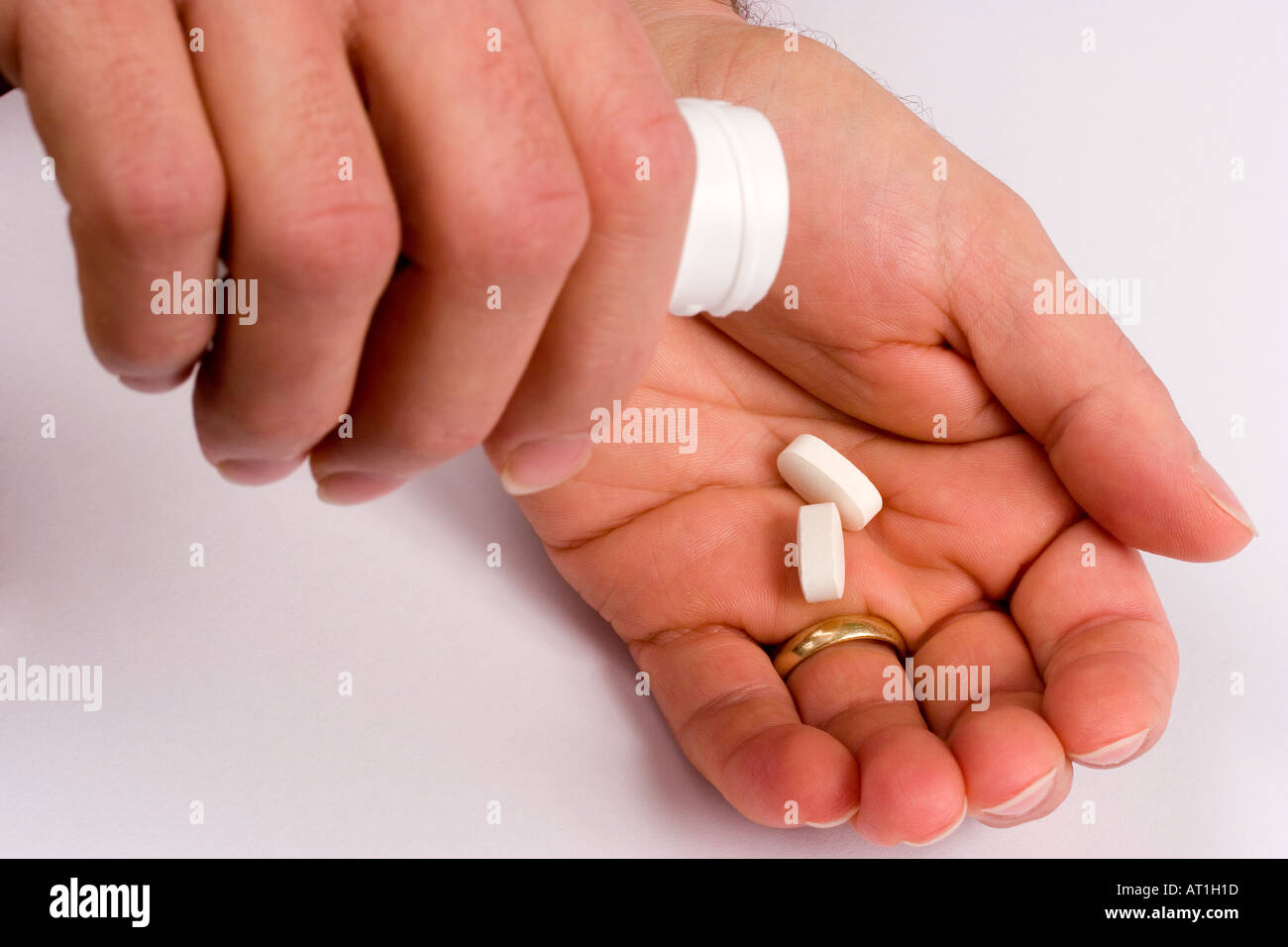 Glucosamine tablets being tipped into hand Stock Photo
