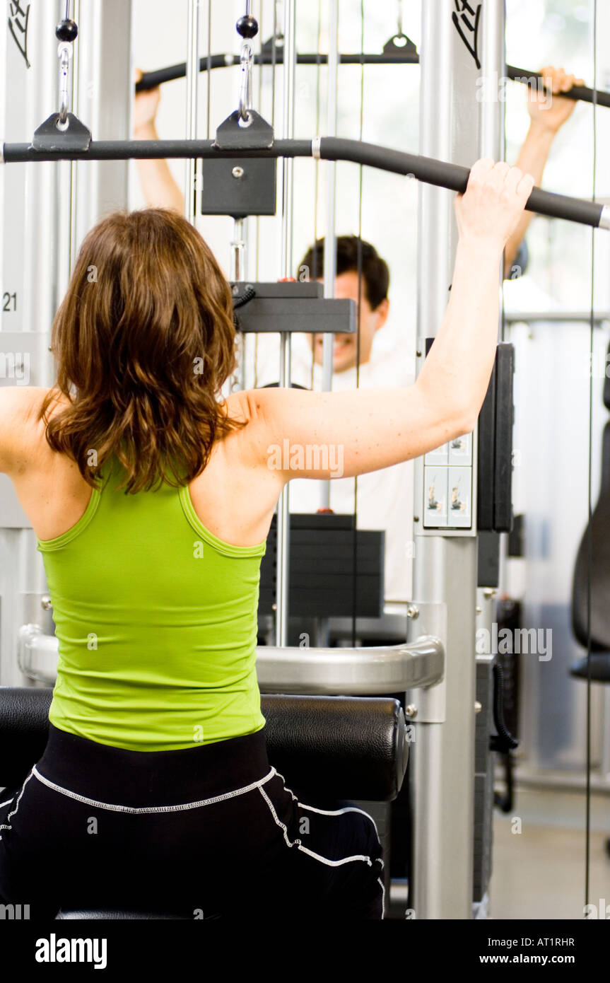 Woman Training with Weights on a Gym Machine Stock Photo