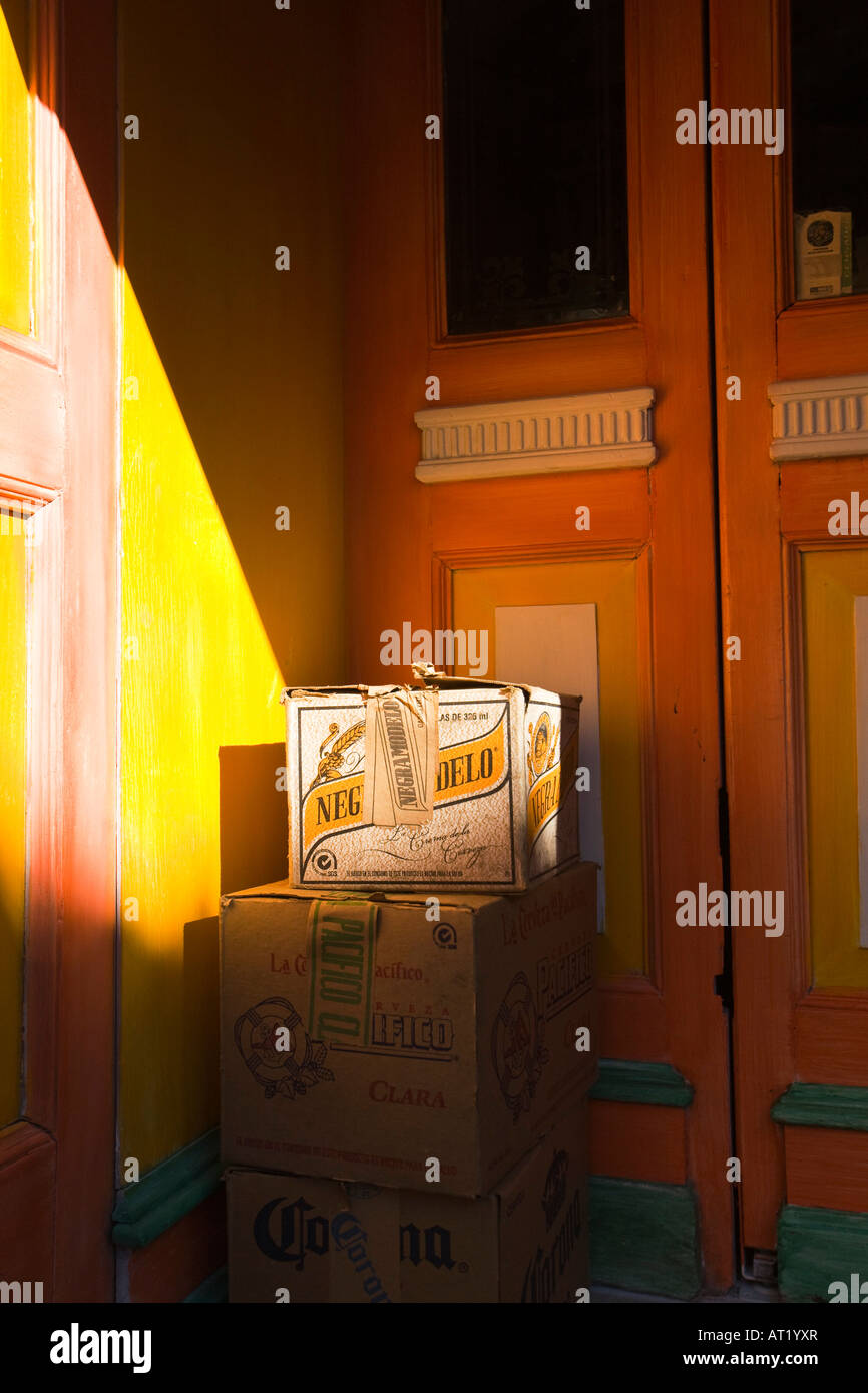 MEXICO Guanajuato Boxes of Negro Modelo Mexican beer and alcohol outside bar doorway in early morning Stock Photo