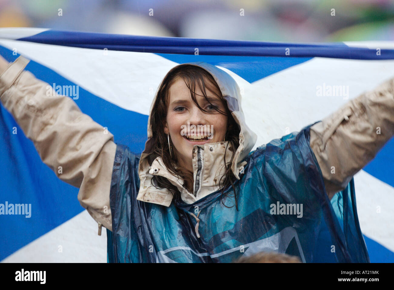 A female Scotland fan in the rain Stock Photo