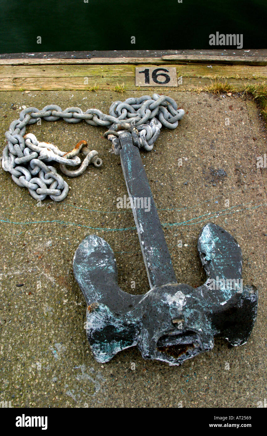 A boat s anchor sits on a dock Stock Photo Alamy