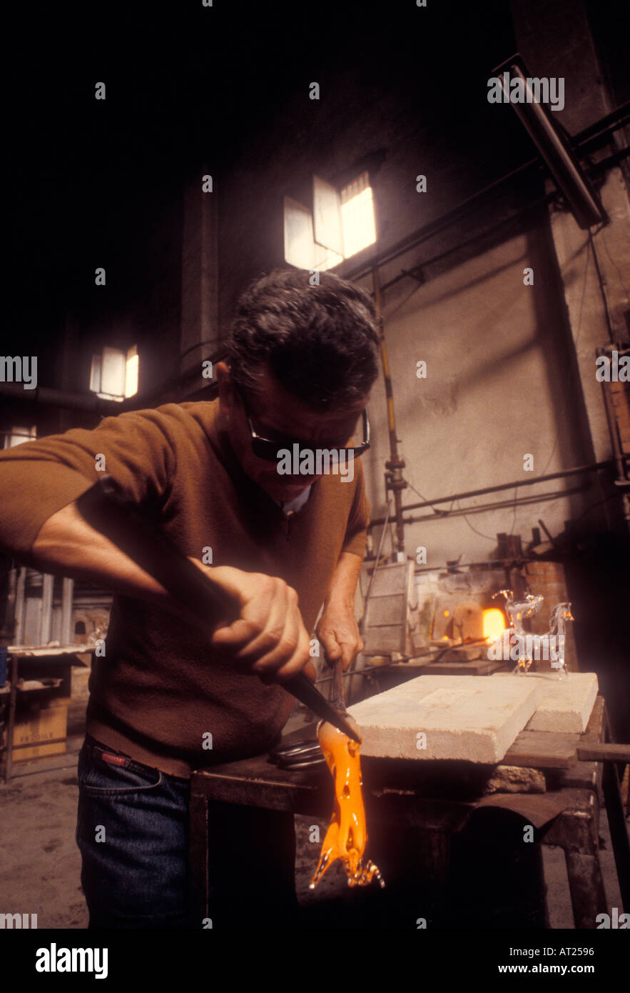 MURANO GLASSMAKER ARTIST glassmaker shapes molten glass into a