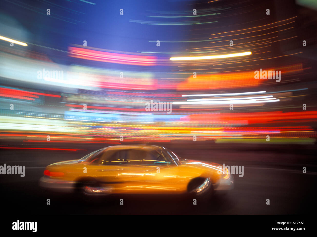 Yellow cab streaks through Times Square New York City USA Stock Photo