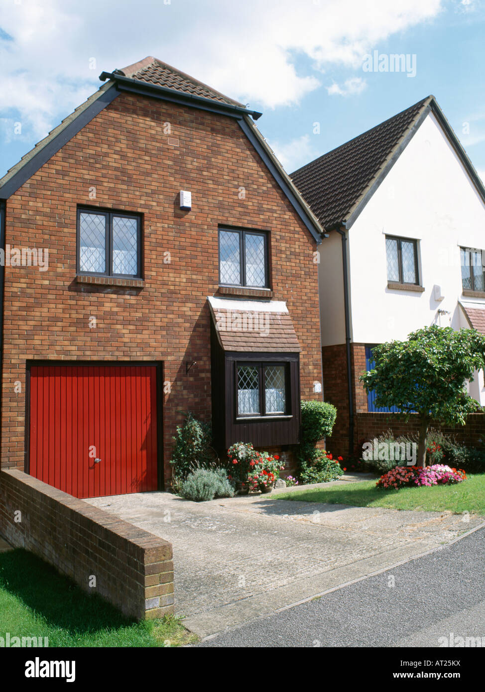 Red Garage Doors On Small Detached Newbuild House Stock Photo