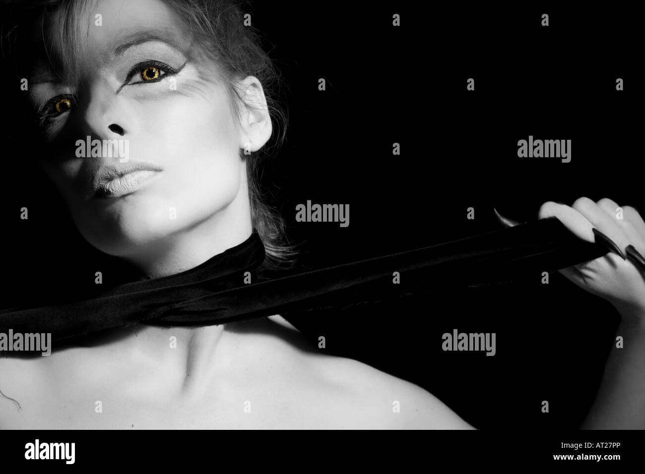 Beautiful woman with wolf eyes on black background Stock Photo - Alamy