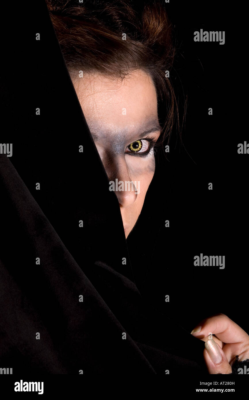 Mysterious woman with yellow wolf eyes and bloodshot eyes Stock Photo