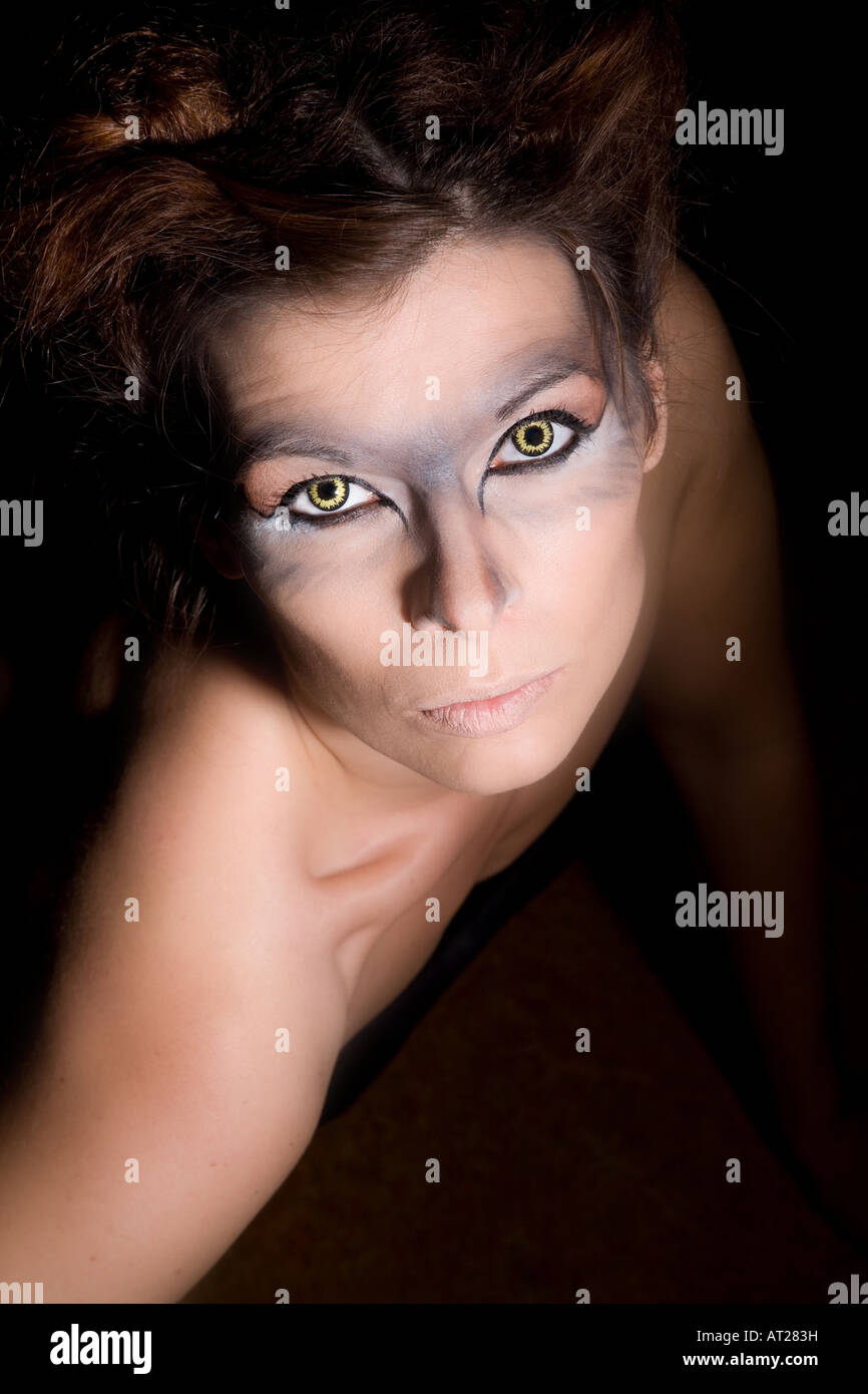 Beautiful woman with wolf eyes looking up from below Stock Photo