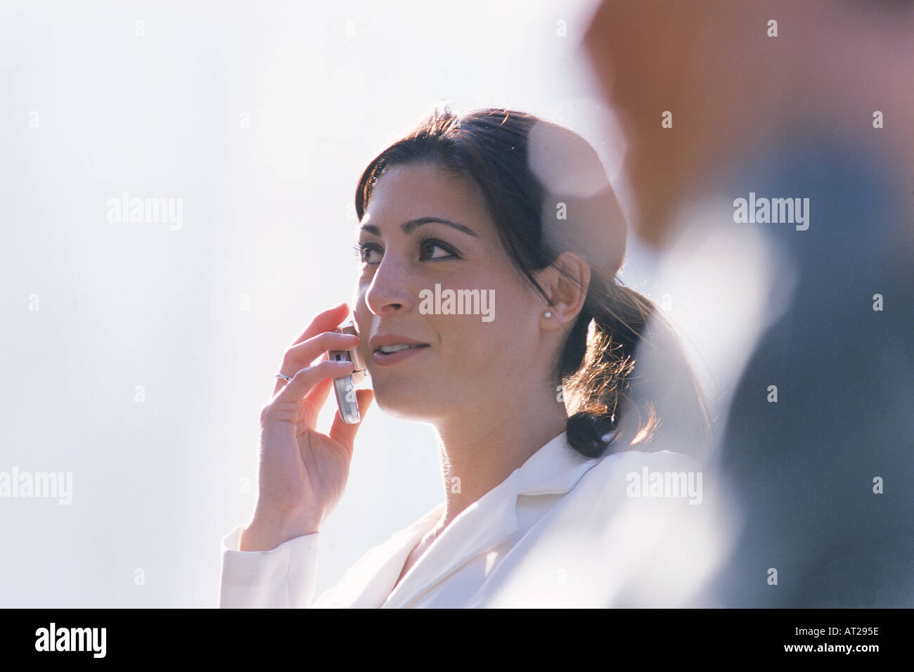 Hispanic woman talking on cellphone outdoors Stock Photo