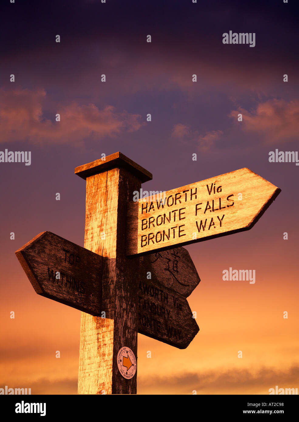 SIGN POST HAWORTH VILLAGE VIA BRONTE FALLS BRONTE WAY AT SUNSET Stock