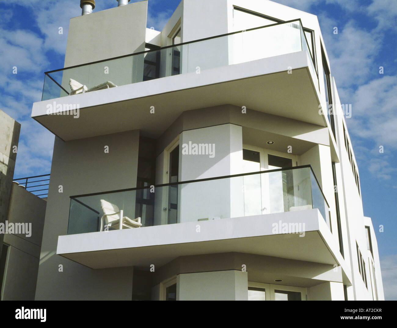 Balconies with glass walls on modern white apartment building Stock ...