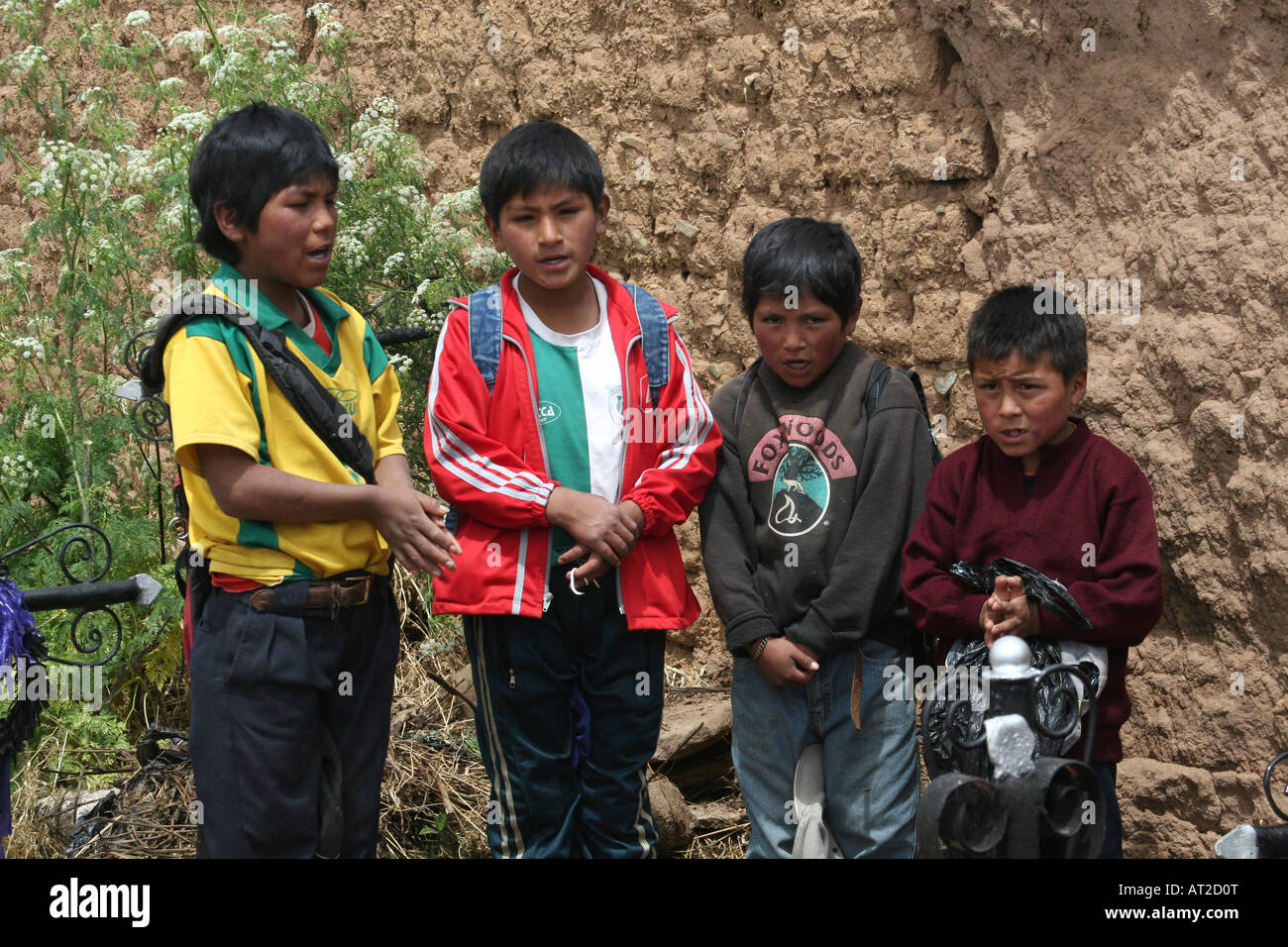 A group of children praying in front of a grave during Todos Santos in Llallagua, Potosi, Bolivia Stock Photo