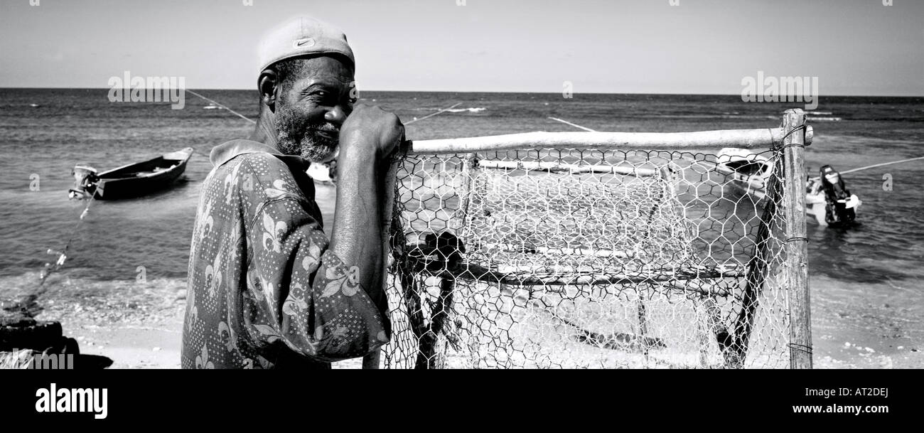 Panoramic black and white of a local fisherman on the beach in Jamaica Stock Photo