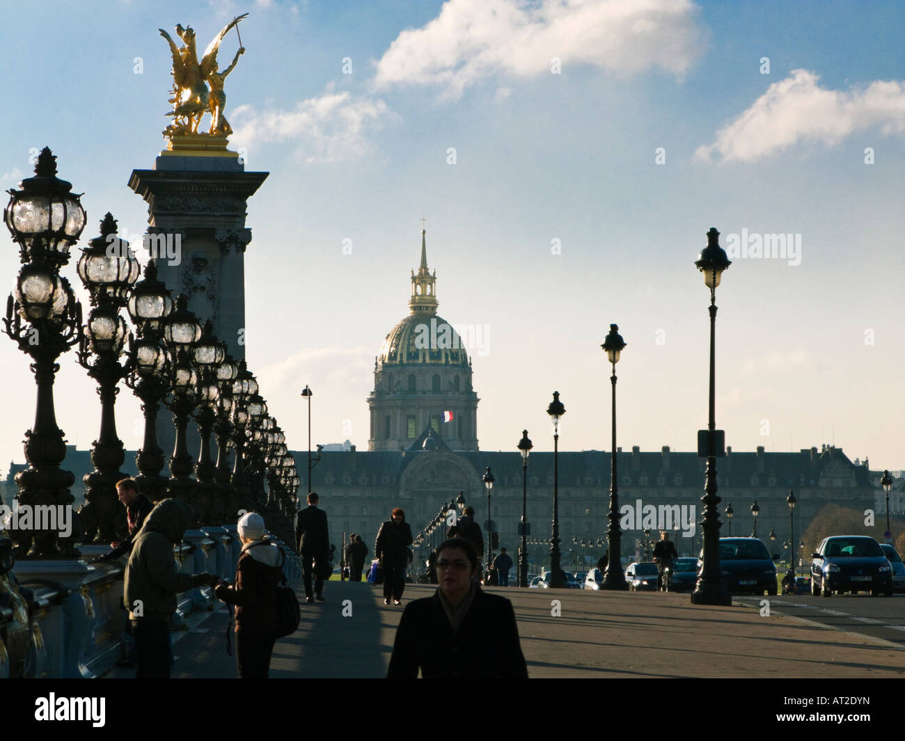 Paris street - People crossing the Pont Alexandre III bridge Paris France Europe looking towards Les Invalides in early morning Stock Photo