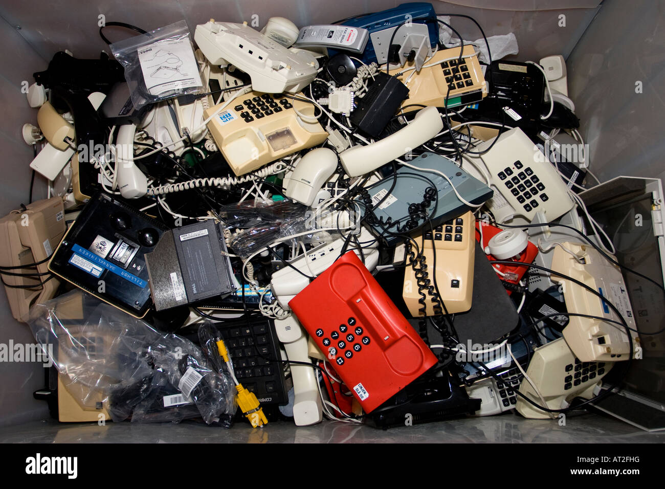 Old telephones for recycling in a container Stock Photo Alamy