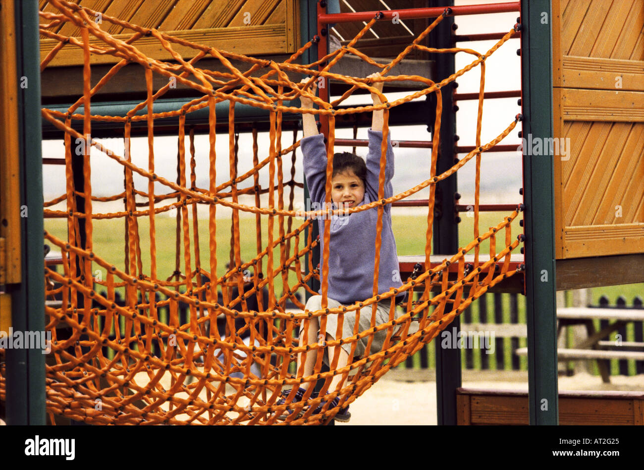 A girl playing on a climbing frame Stock Photo