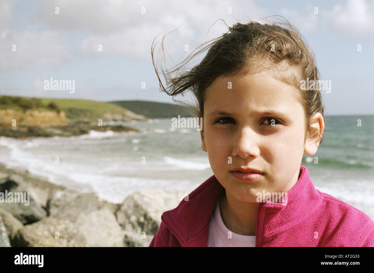 A portrait of a girl standing in front of the sea Stock Photo