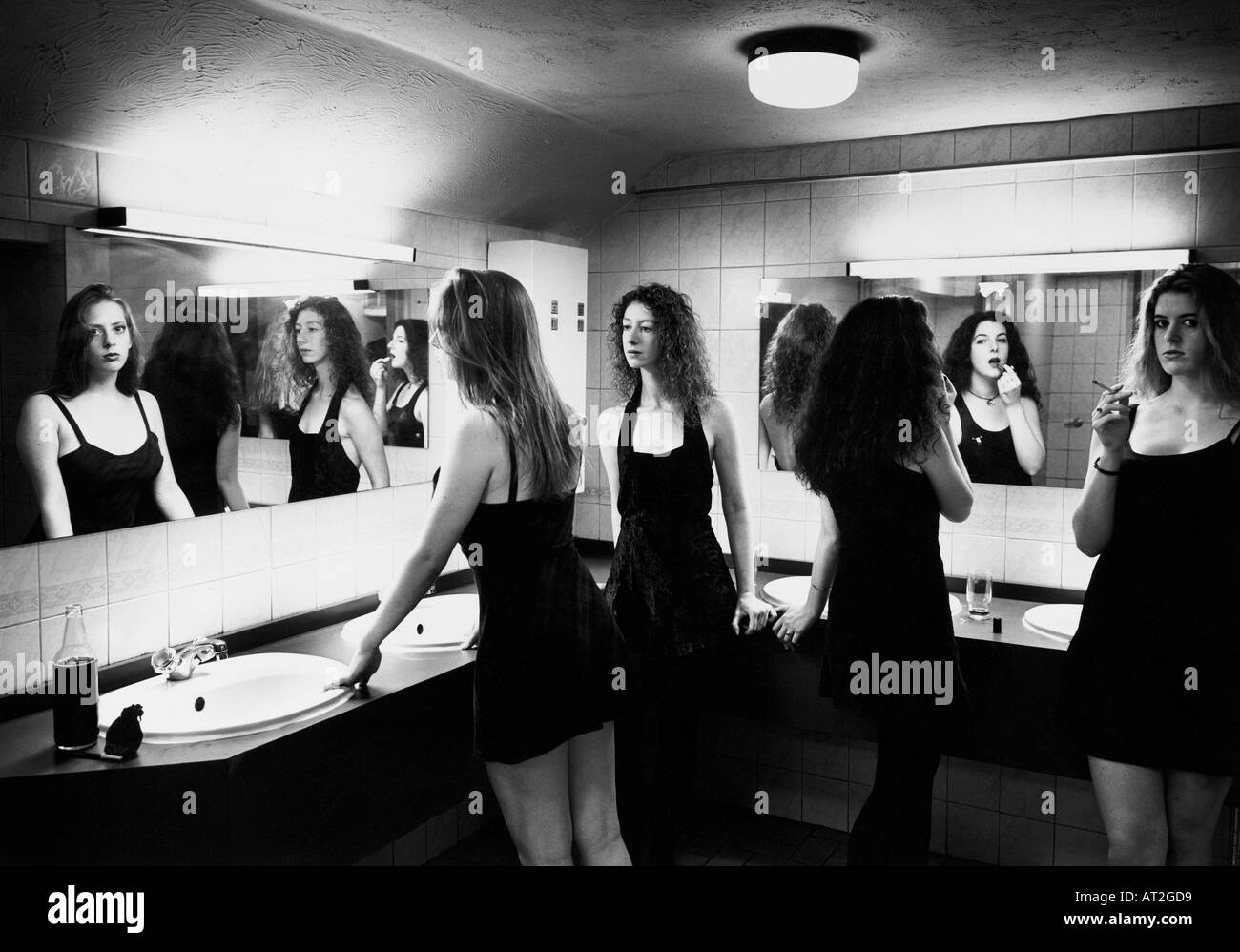 Girls applying make up in a rest room in a club Stock Photo