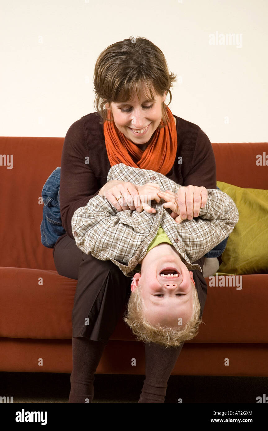 Mother playing with her son on the couch Nice family picture Stock Photo