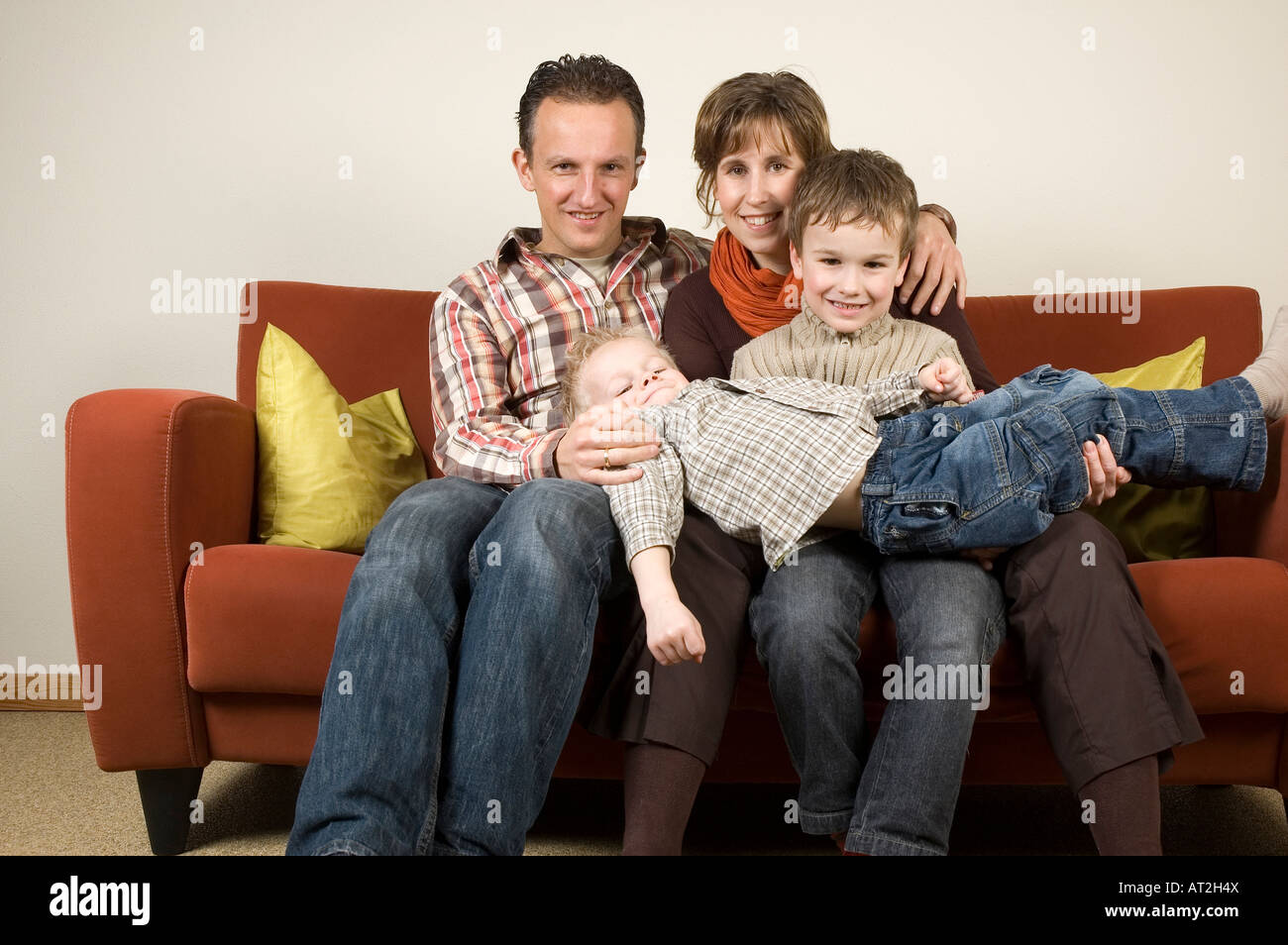 Nice family picture sitting together on a couch Stock Photo