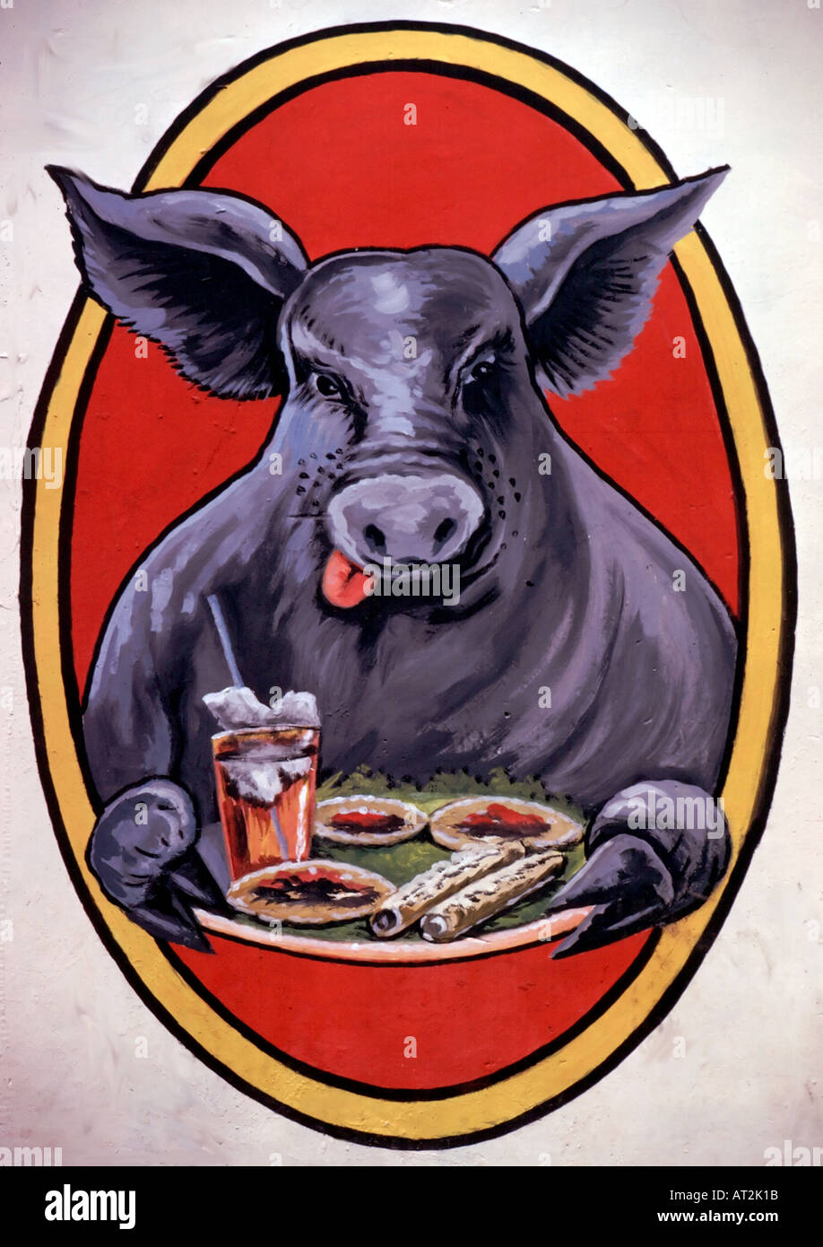 A happy bull is ready to enjoy a Mexican meal in this mural on a restaurant wall in Oaxaca Mexico Stock Photo