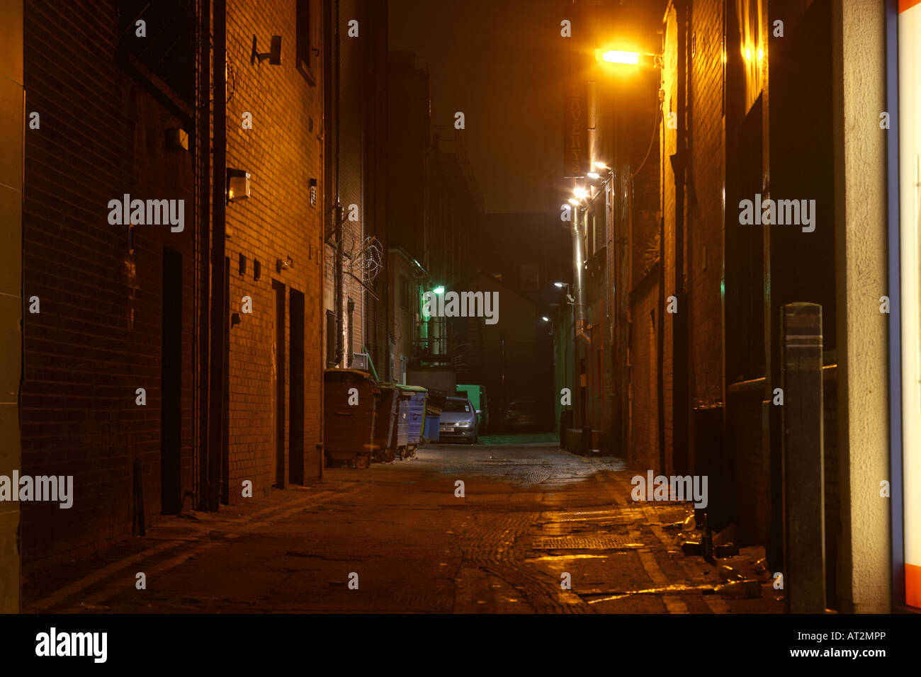 narrow deserted alleyway backstreet empty behind shops and bars in belfast city centre Stock Photo