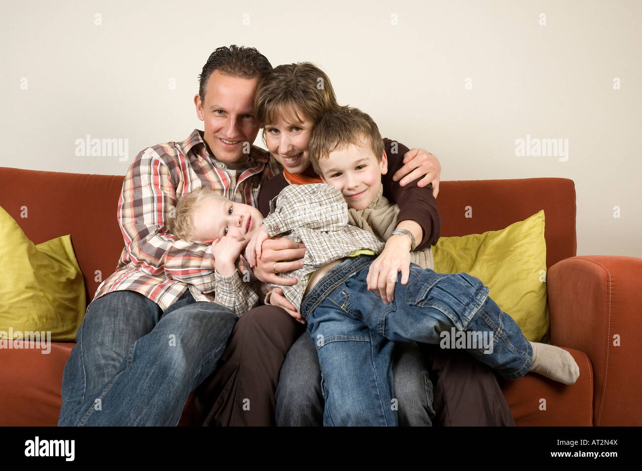 Nice family picture sitting together on a couch Stock Photo