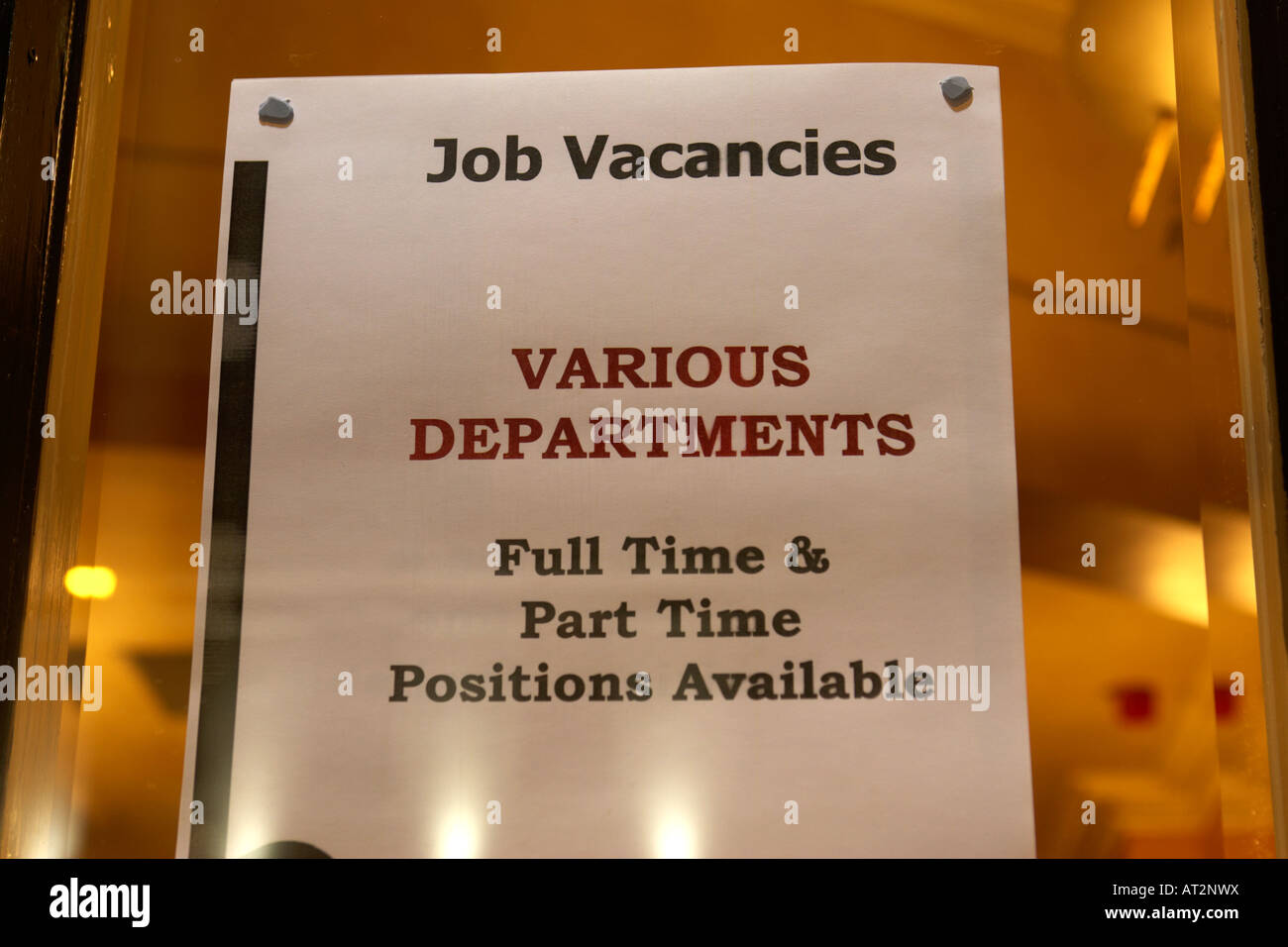 job vacancies notice posted in the window of a pub and hotel at night in tourist pub club area of belfast hospitality vacancies Stock Photo