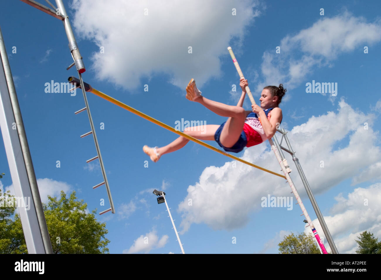 High school girl attempting a pole vault in a track and field meet