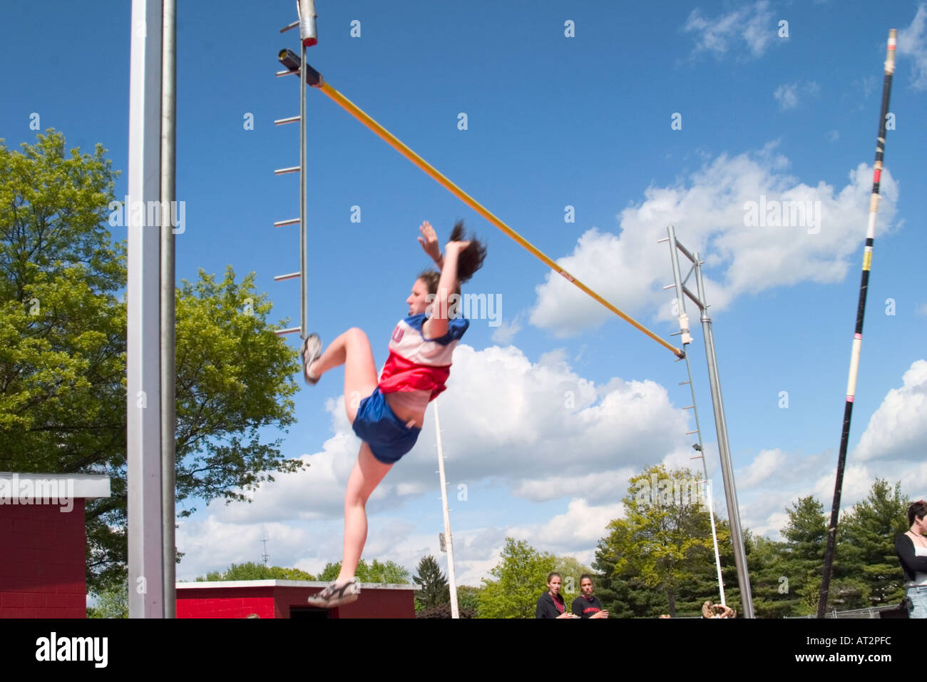High school girl attempting a pole vault in a track and field meet