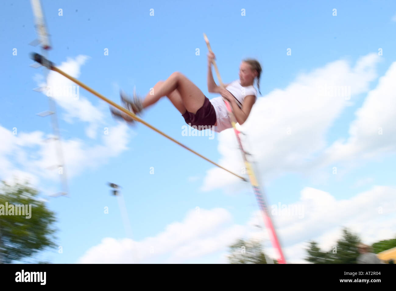 High school girl attempting a pole vault in a track and field meet