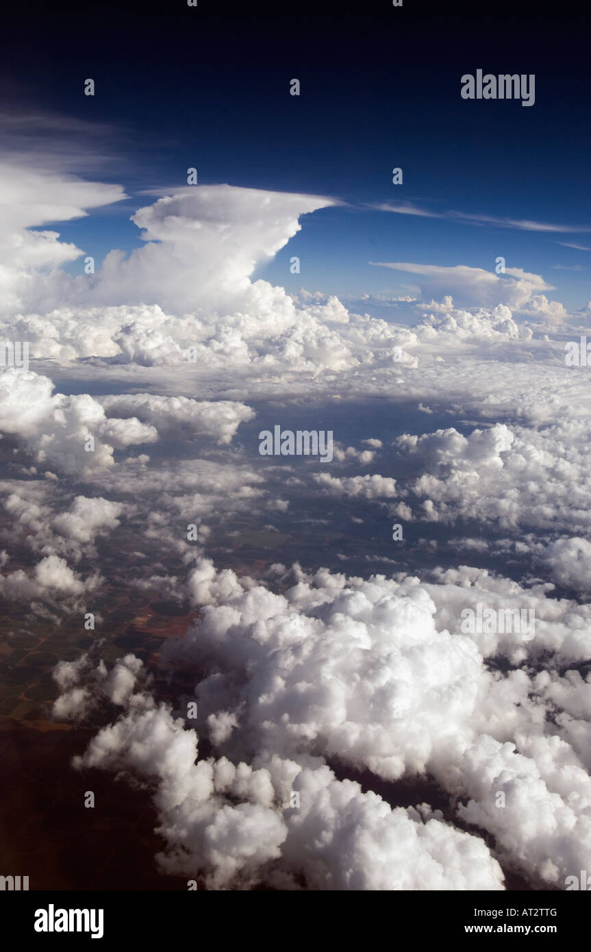 Picturesque aerial sea of high noon fluffy Clouds in a blue Sky with cool colors in a vertical technicolor view Stock Photo