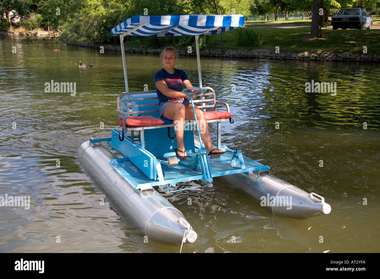 Fifteen year old girl uses a paddlewheel boat on the lagoon in Julia