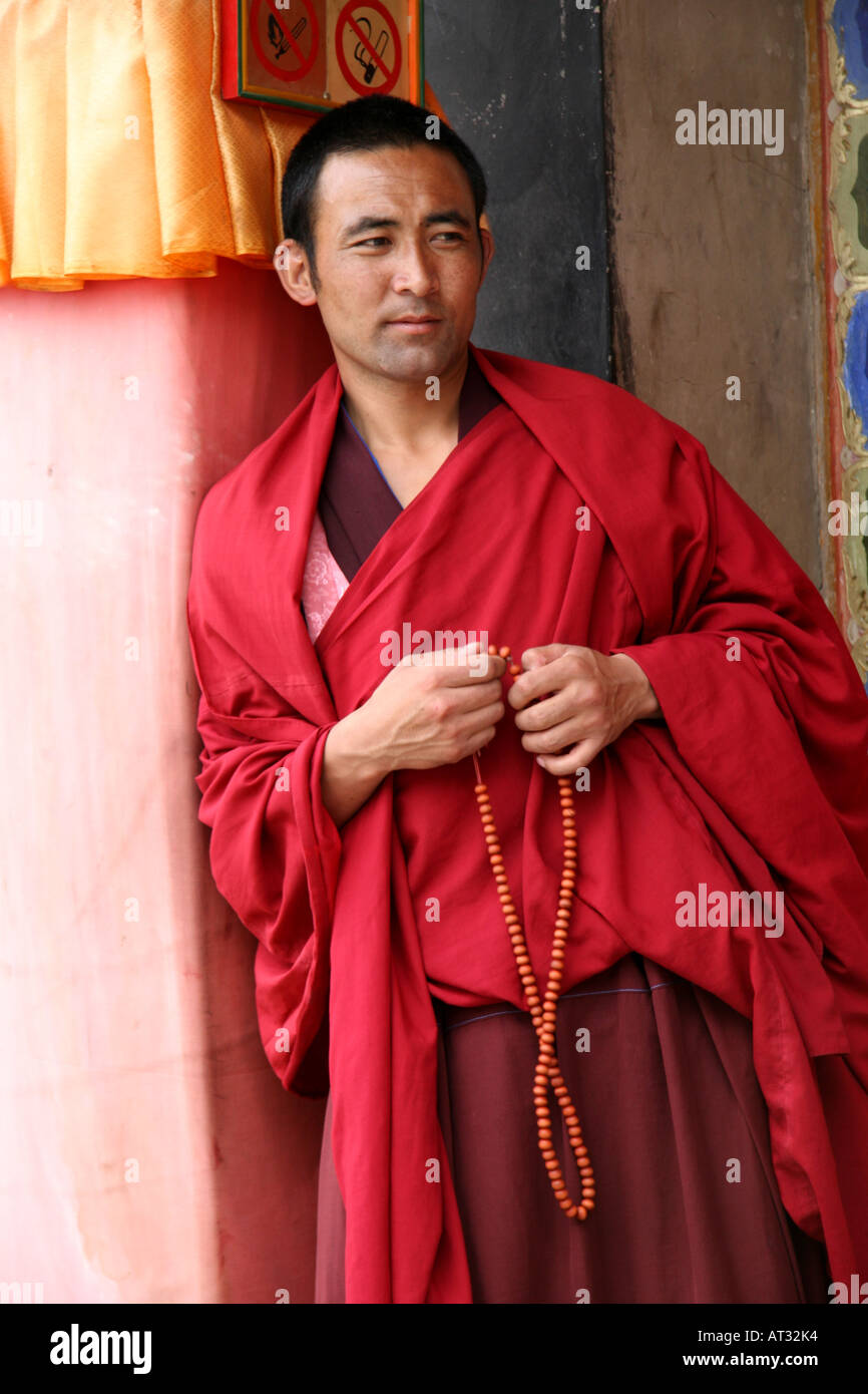 Buddhist monk with his prayer beads at the famed Labrang Buddhist Monastery, Xiahe, China Stock Photo