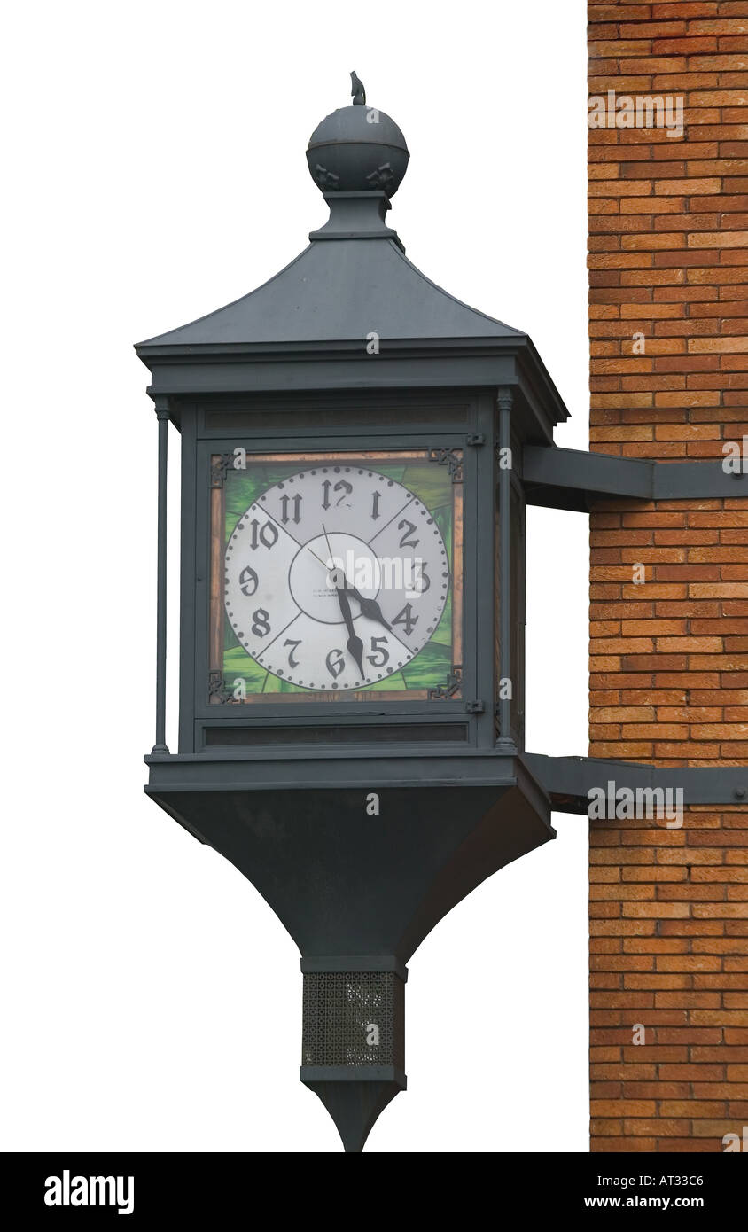 Wall mounted street clock silhouetted on white background Stock Photo