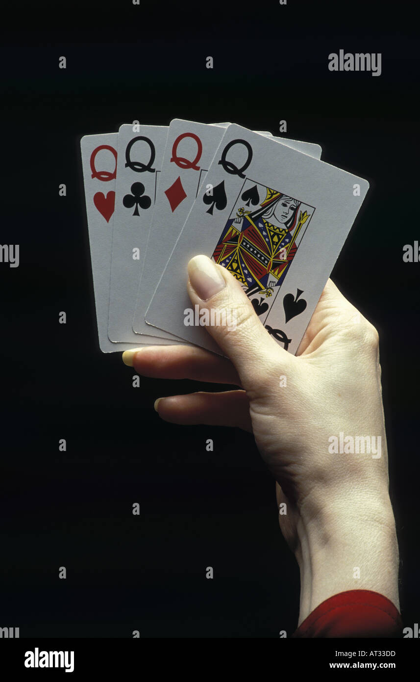 Woman s hand holding four queens Stock Photo