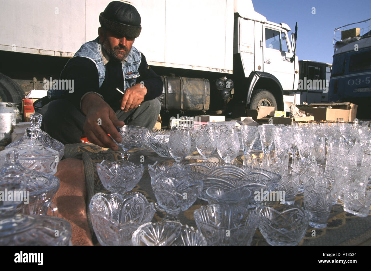 Dagestani prilgrim on his way home from the haj to Mecca sells glassware in Amman Jordan Stock Photo