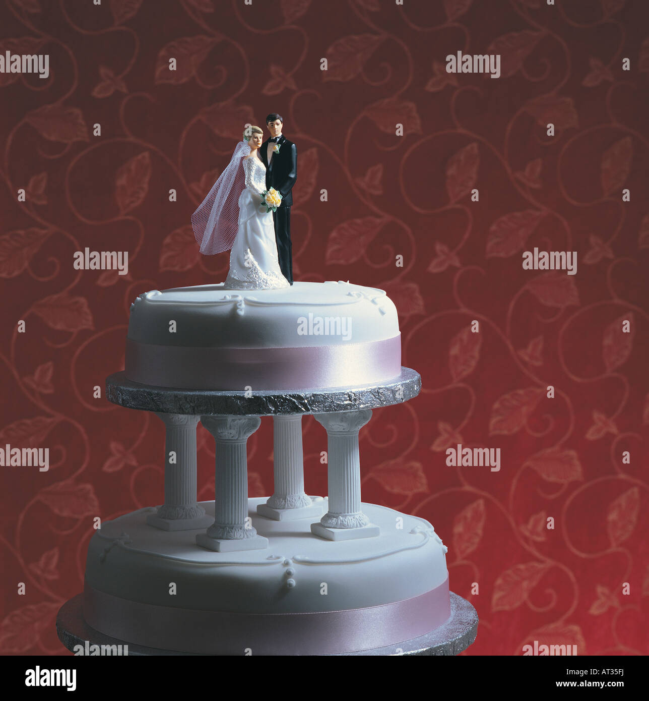 A wedding cake, bride and groom standing together Stock Photo