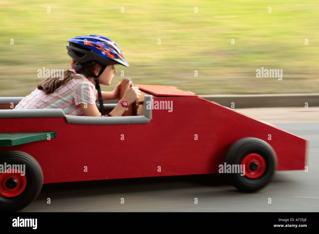 A young girl is driving a soapbox. Stock Photo
