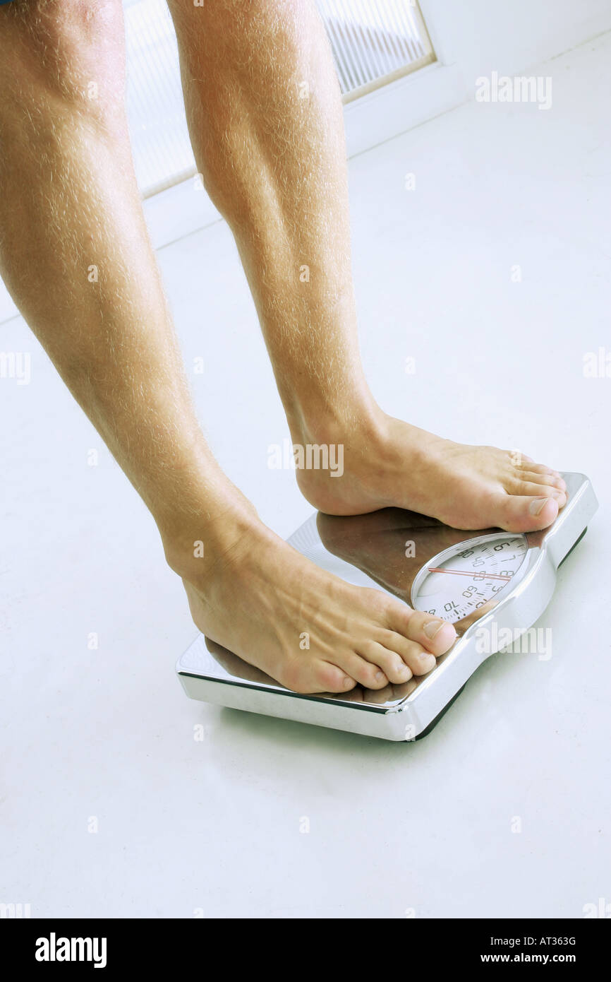 A man standing on bathroom scales - close-up Stock Photo